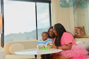 Family Reading The Sandbox Series Together sitting down at the table