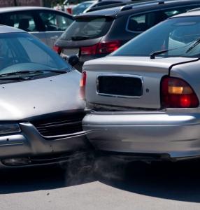 Car crash between two silver cars in a parking lot