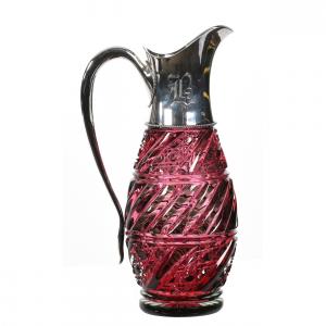 American Brilliant Cut Glass pitcher, 11 ¾ inches tall, with cased cranberry/green cased overlay, a pillar and cane swirl design, ray cut base sterling silver spout and handle marked Gorham, sold in the Nov. 12 auction ($19,000).