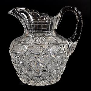 American Brilliant Cut Glass pitcher, 11 ¾ inches tall, with cased cranberry/green cased overlay, a pillar and cane swirl design, ray cut base sterling silver spout and handle marked Gorham, sold in the Nov. 12 auction ($19,000).