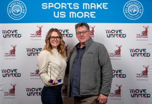 Amy Purdy holding her award and posing with Glenn Merry