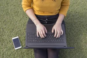 Person typing on a computer.