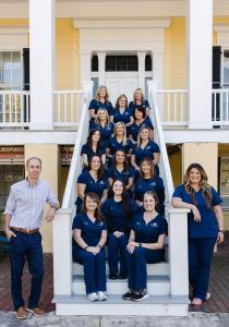 Rogers and Andrews Orthodontics team sitting on stairs