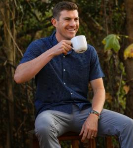 Brandon Lucero, founder of New Generation Mastery Podcast drinks hot coffee outside