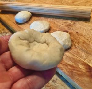 A perfectly rolled tortilla starts with a testal, a pillow-like ball of dough, pinched at the ends