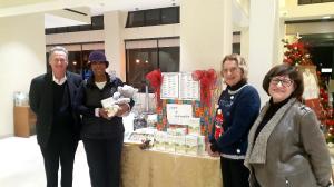 This is a photo of Church Staff showing Sharon Wright of Carol's Christmas the Gifts  donated.