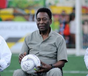 Photo of soccer great Pelé holding a ball from the sport.