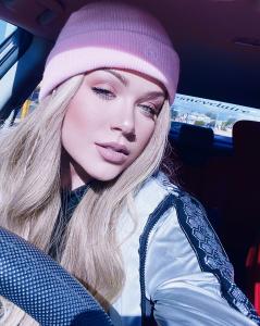 Beautiful blonde in a pink beanie. Big blue eyes and a beautiful singing voice