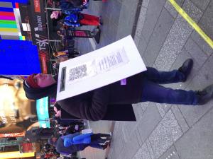 Christopher Day in a wearable sandwich board promoting Stenonymous at Times Square
