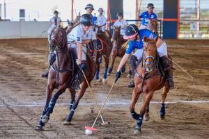 Two women arena polo players on horses