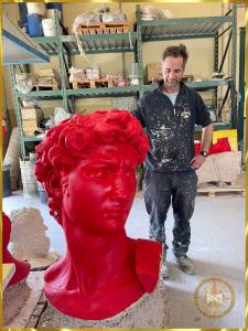 Artisan next to flawless red wax of the David by Michelangelo in the Foundry Marinelli facility before being carefully packaged