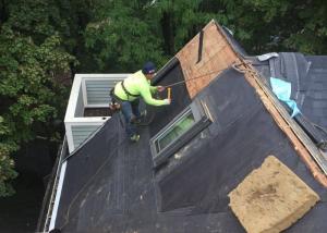 Worcester roofer completing a roof replacement on a home