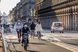Cyclists using a dedicated bike lane in Paris, France.