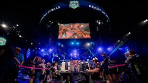 Photo of children ages 8 - 17 sitting at computers competing in an esports tournament. Two teams are facing each other, heavily focused on the competition.