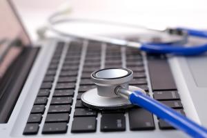clinical software managment relating with laptop and stethoscope