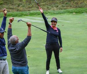 Robyn James, inventor of Infusenclip and founder of Birdie Everything, celebrates sinking a putt.