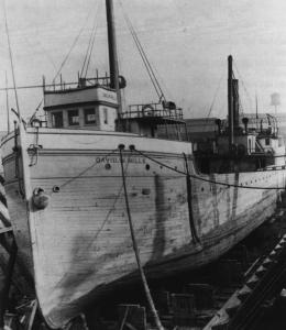 old ship at dock with name David W. Mills on front.