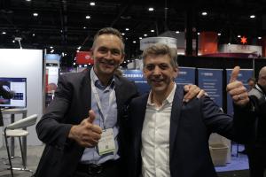 Two men, contextflow Chief Commercial Officer Marcel Wassink and Medexprim CEO, smile at RSNA 2022