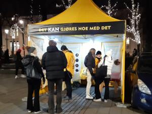 Scientology Volunteer Ministers reach out in Oslo from their bright yellow tent.