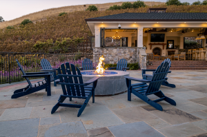 Outdoor firepit with a large hillside backdrop.