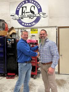 Frank Schneider (F-S Truck & Trailer Repair) and Tom Wiers shake hands during the integration
