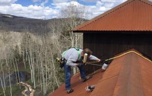 Get Bats Out Technician performing Residential Bat Removal on roof using harnesses