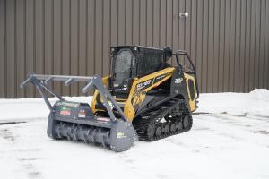 A track loader with a Loftness mulching head attached to the front.