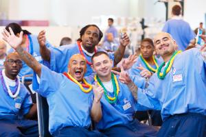 Incarcerated individuals celebrate during entrepreneurial training program