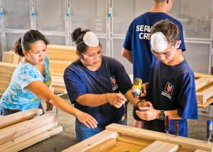 2 volunteers building a headboard for our beds before we deliver them to kids in need within our own community