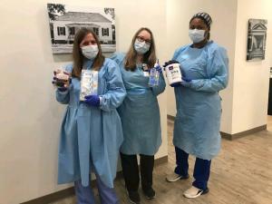 Lowcountry Urgent Care employees holding tissues, sanitizing wipes, and goodie bags