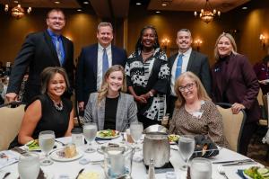 Sylvania Chamber dinner event with group photo of members together at a table