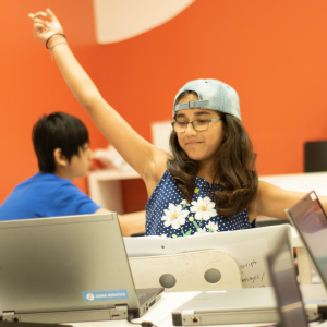 Zebra Robotics student celebrates a successful line of computer code.