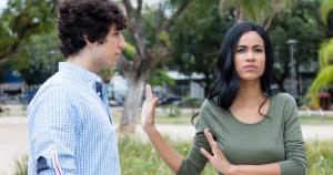 girl putting hand up rejecting boy