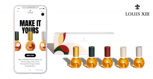 A mobile phone scans the QR Code on the Louis XIII THE DROP collection box to activate a personalized mobile experience.