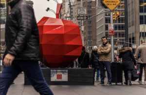 Artist Enrique Cabrera stands near his red La Gran Manzana apple sculpture at 1251 Avenue of the Americas in New York City.