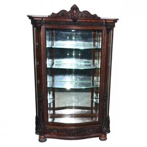 Quarter sawn oak china cabinet in the Ribbed Egg pattern by R.J. Horner, 89 inches tall, with bun feet, beveled S-curve glass door and sides, one drawer and three glass shelves (est. $6,000-$10,000).