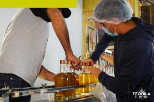 Two men at Tequila and Spirits Mexico distillery, producing premium tequila to meet the growing demand for premium tequila in the United States