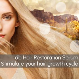 Blonde woman with hair blowing in front of desert background