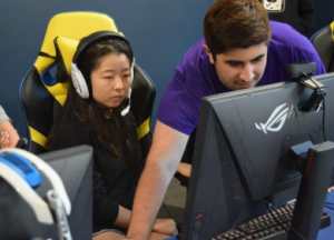 This picture captures an esports player being coached on in-game strategies and tactics