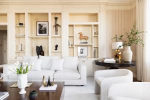 The living room at 781 Fifth Avenue, Apt 27T at The Sherry-Netherland, designed by Interior Marketing Group in a neutral color palette.