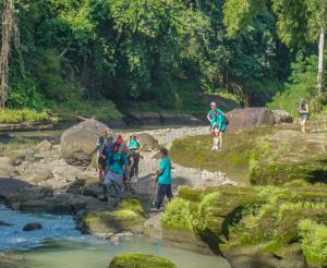 Participants walking through the Yeh Ho river in Tabanan, back in 2021's MMM.