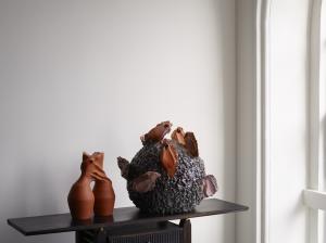 erracotta sculpture by Bisila Noha represented by Thrown Gallery (Left) and ceramic sculpture earthenware by Noa Chernichovsky represented by Charles Burnand Gallery (right), sit atop Eland Console by Sandy Buchanan, Flow Gallery, presented at Collect 2023