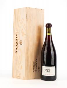 A 750ml bottle of 1947 Domaine Faiveley Musigny rare red Burgundy wine in Acker's La Paulée Auction March 2-3 pictured with original wood case against white background.