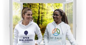 Two happy female friends wearing Open Dialogues and My Zalu t-shirts, celebrating their shared values.