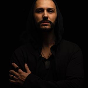 Hussein Atout, A silhouette of a person standing in a dark space