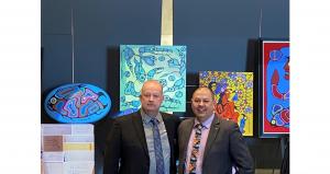 OPP Det. Insp. Kevin Veillieux and Thunder Bay police Det. Sgt. Jason Rybak, left to right, stand in front of a series of fraudulent Norval Morrisseau paintings