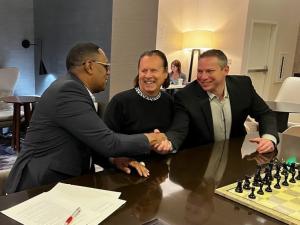 Percy Miller shakes hands with Jeff Barnes, CEO of Angel Investors Network with Bernt Ullmann, Chief Brand Accelerator and Board Member of Launch Cart.