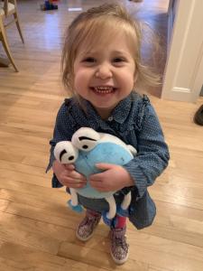 Young girl smiling hugging Lensy