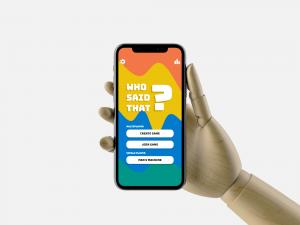 Robot hand holding a phone with the Who Said That? app open
