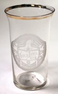 Gold Label Beer glass with partial gold on the rim, stenciled, “It’s in The Brewing” / Gold Label Beer / Brewed and Bottled By / The Walter Brewing Co. / Pueblo, CO” (est. $500-$1,000).